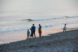Adults and children playing on a beach